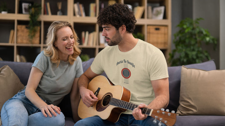 Cozy couple, man is wearing a Beige t-shirt with acoustic guitar graphic and &