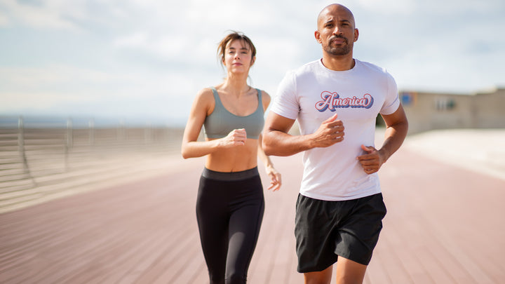 Man and woman running outdoors White t-shirt with &