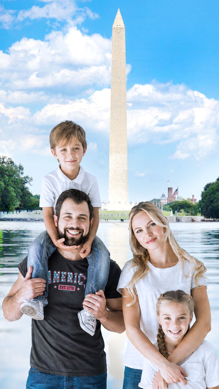 A family of four posing together in front of a Washington Monument backdrop. The father wears a Black t-shirt by America The Beautiful with &