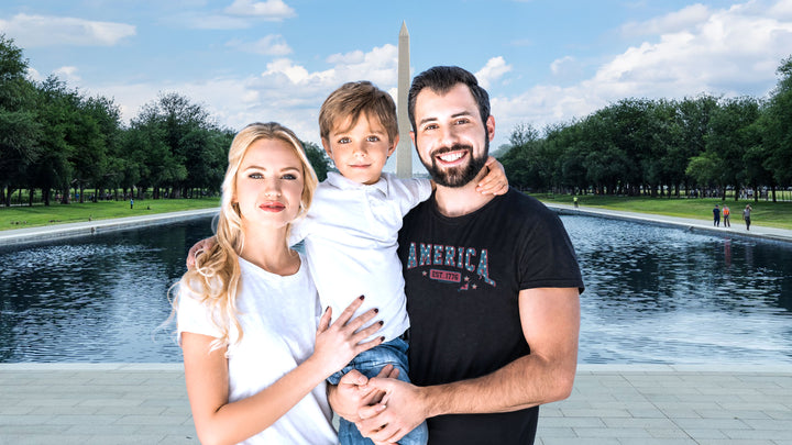 A family of four posing together in front of a Washington Monument backdrop. The father wears a Black t-shirt by America The Beautiful with &