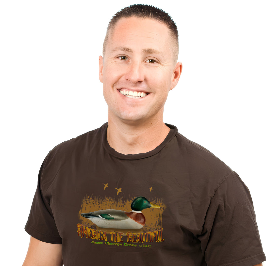 Man wearing a brown t-shirt with a duck design and text on a white background