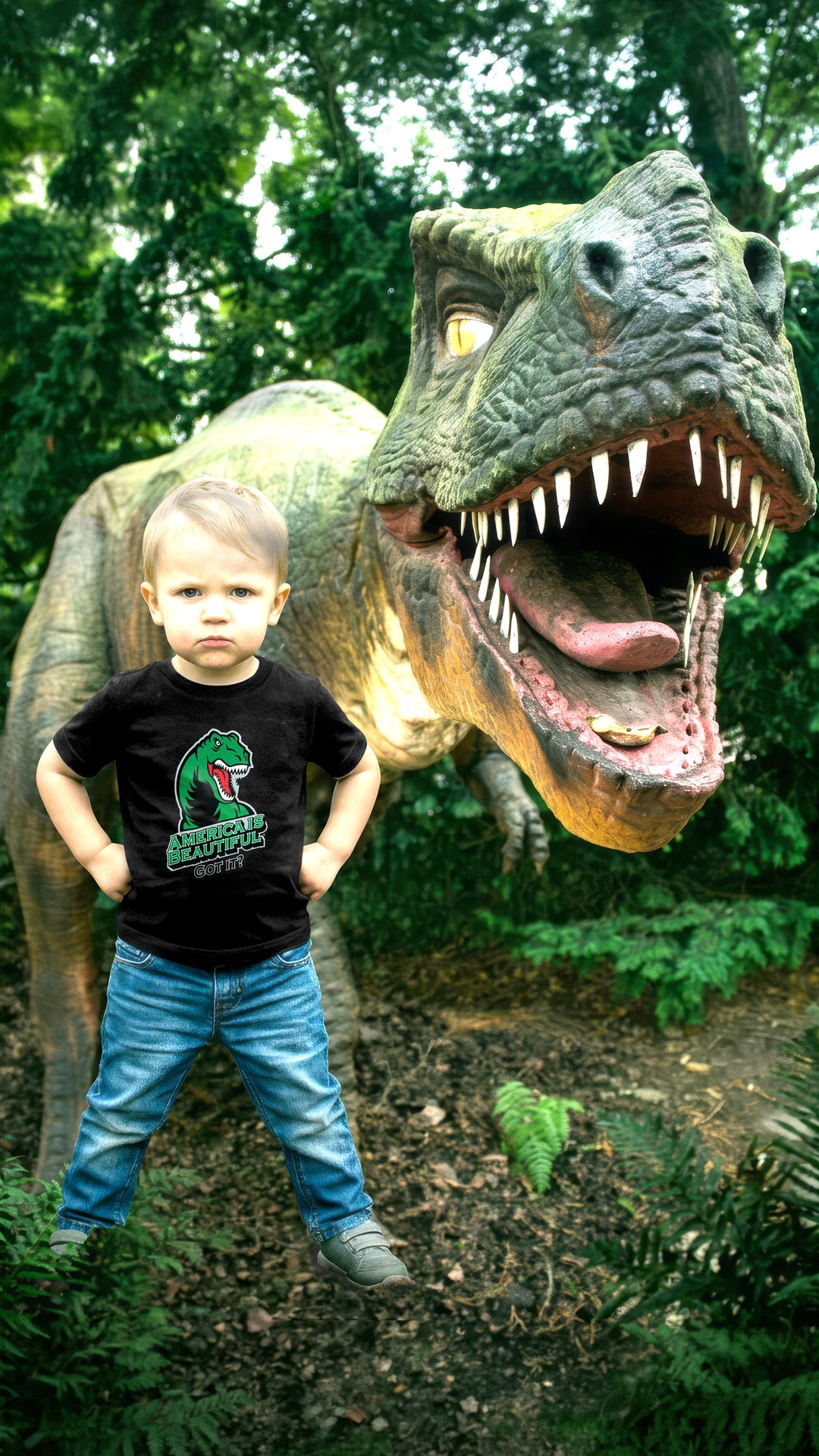 Child wearing a black t-shirt with a T-rex dinosaur graphic in front of a large dinosaur statue.