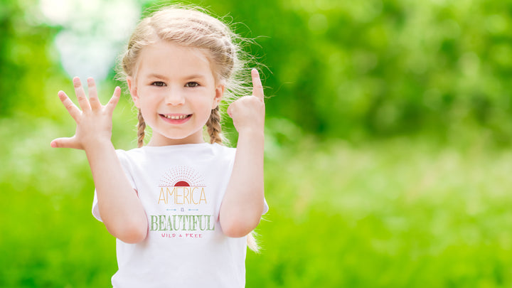 Young girl wearing a White t-shirt with &