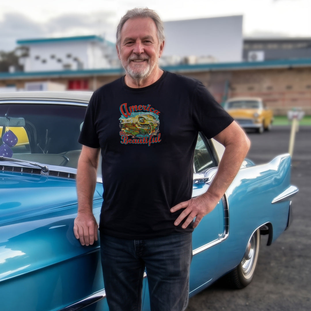 Man wearing a Black t-shirt with colorful graphic of vintage Cadillac and 'America the Beautiful' text