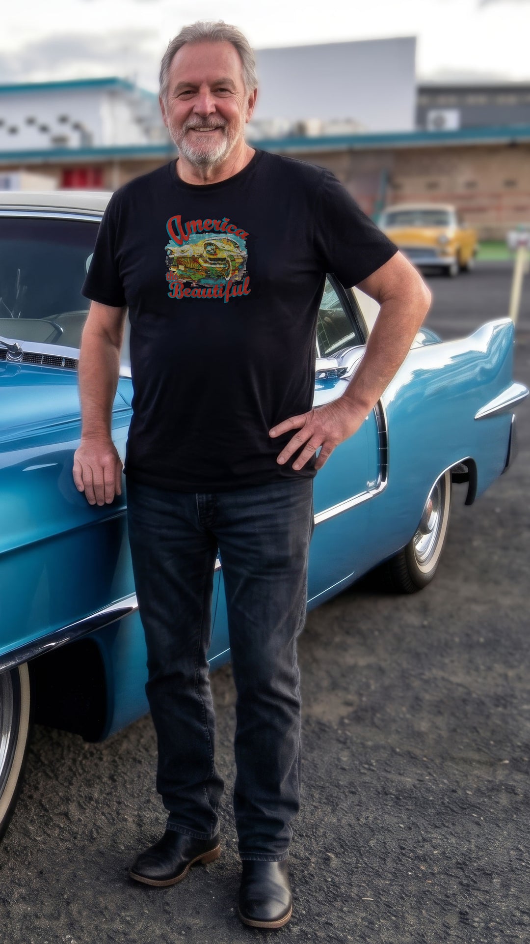 Man wearing a Black t-shirt with colorful graphic of vintage Cadillac and &