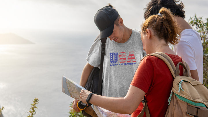Two people hiking with a map, one wearing a America The Beautiful &