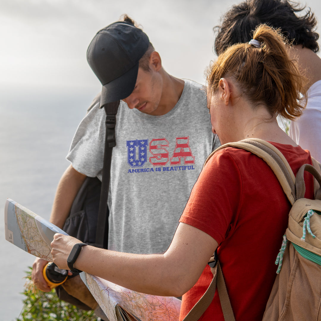 Two people outdoors, one wearing a gray t-shirt with 'USA America is Beautiful' design.