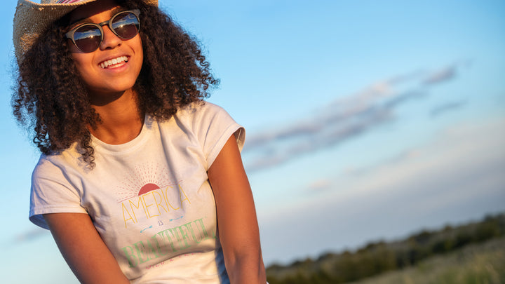 Smiling woman wearing a White t-shirt with &