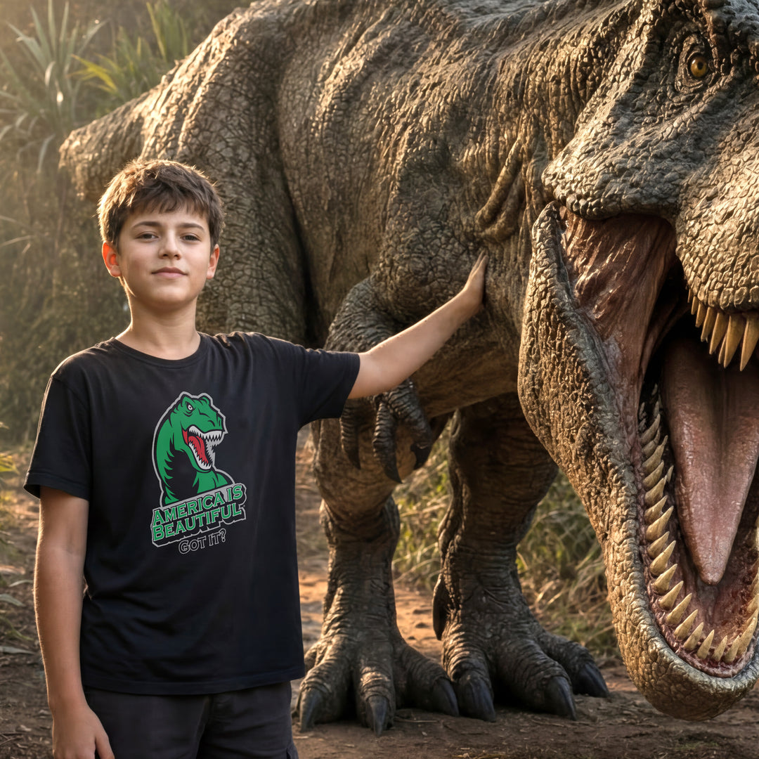 Young boy standing next to a T-rex dinosaur wearing a Black t-shirt with a green T-rex dinosaur graphic and America Is Beautiful text