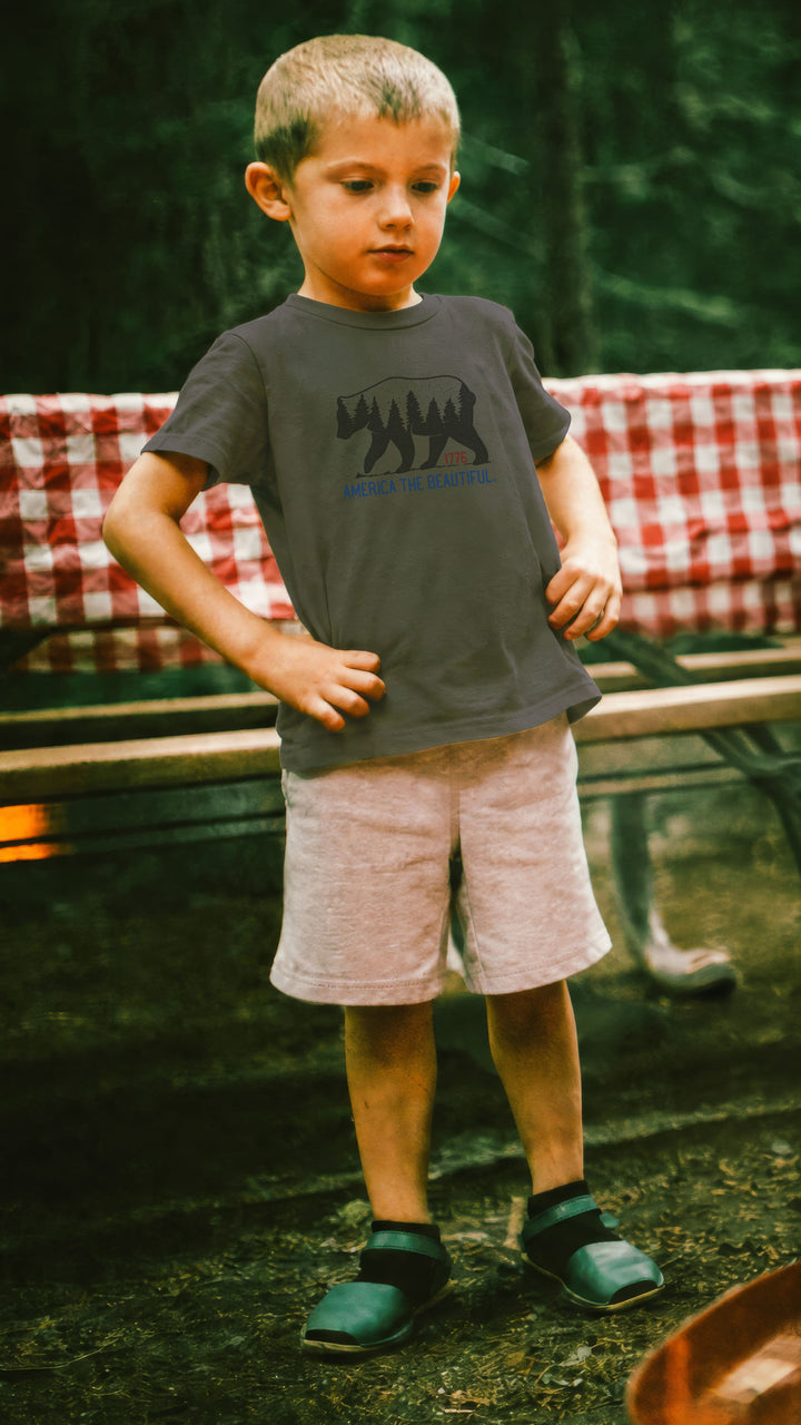 Boy wearing a Military Green t-shirt with bear graphic and &