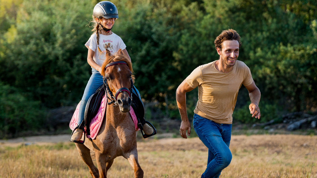 Girl riding horse wearing White t-shirt with horse graphic and &