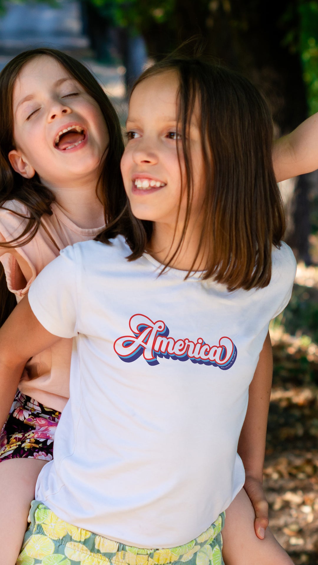 Two young girls, one wearing a &