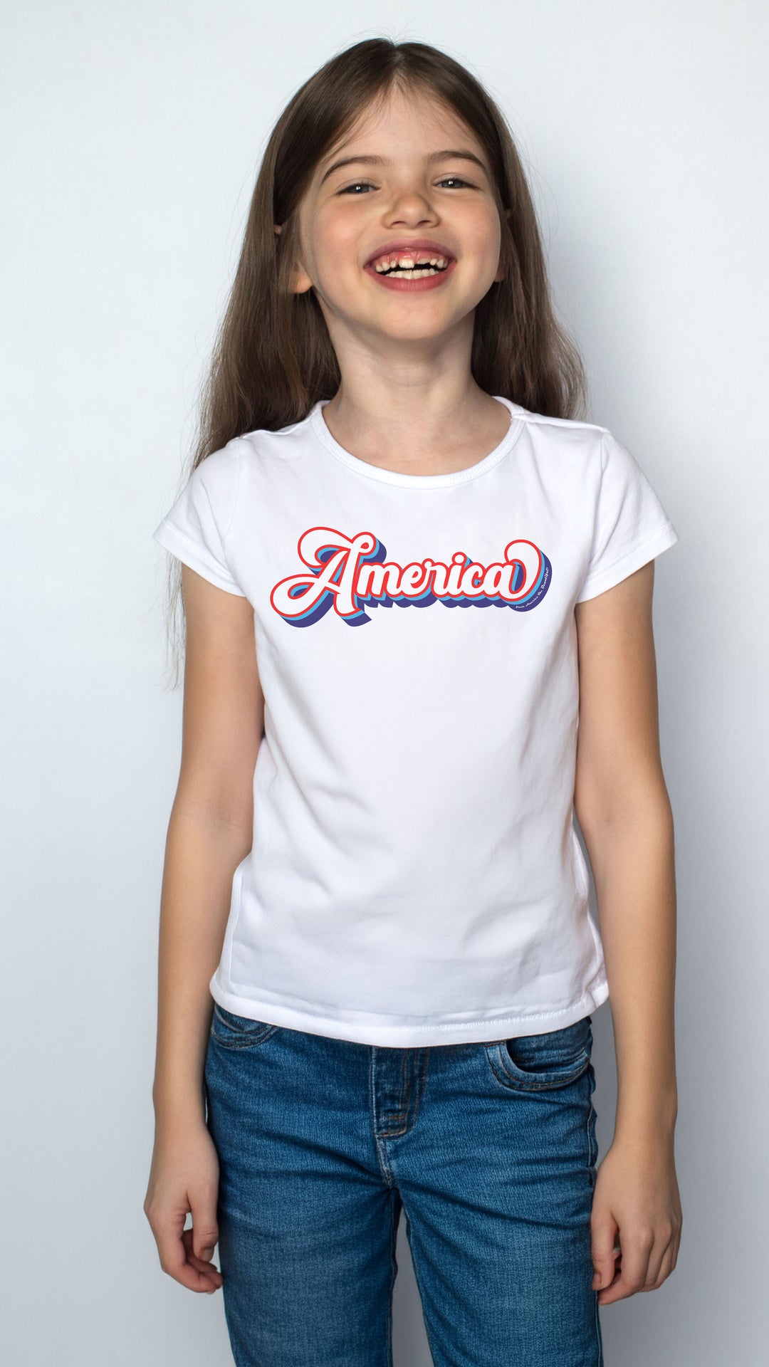 Young girl wearing a white t-shirt with &