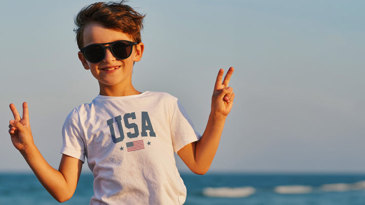 Child wearing sunglasses and a &