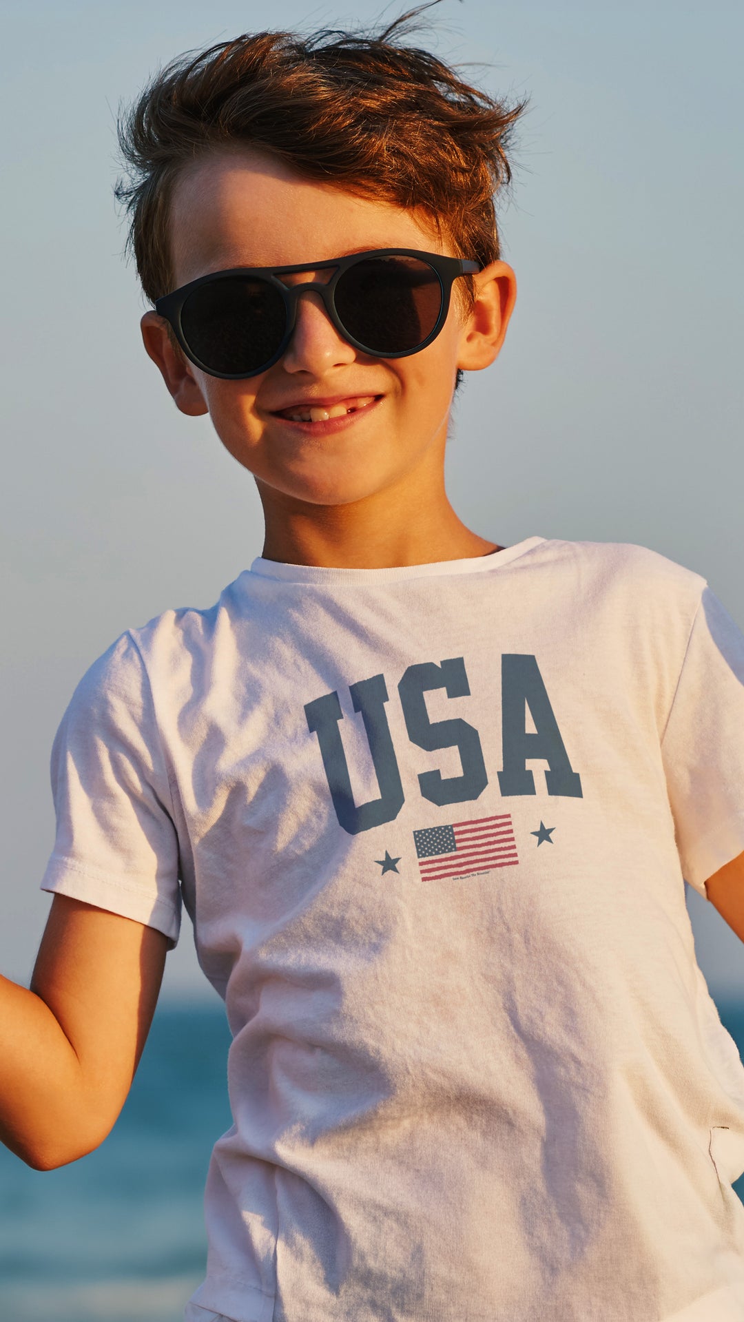 Child wearing sunglasses and a &