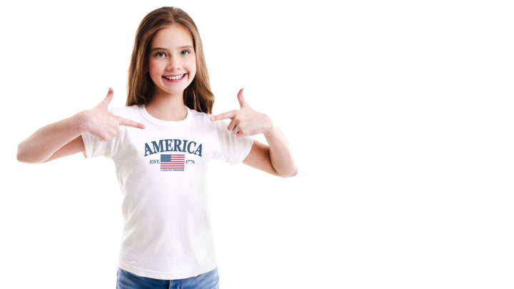 Young girl wearing a white t-shirt with &