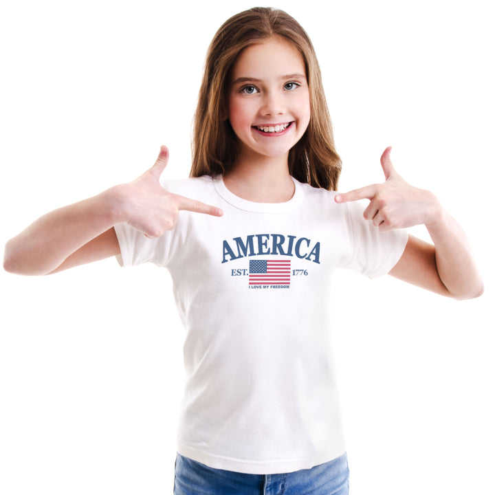 Young girl wearing a white t-shirt with &
