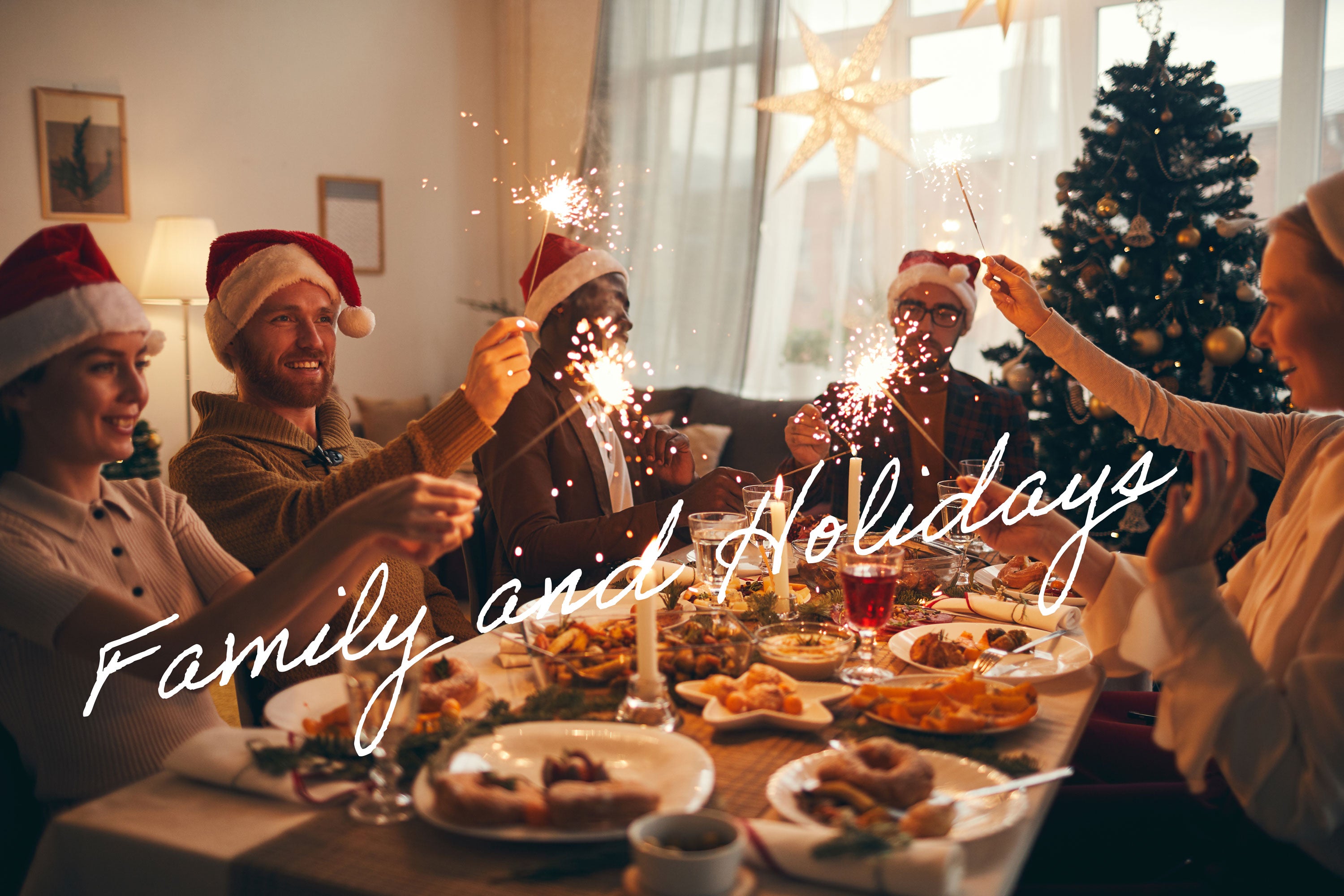 Family around holiday table with sparklers