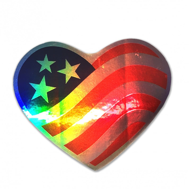 A heart shaped American flag decal with three stars printed on refractive laser foil wherein the red and blue of the flag are printed translucent ink on the foil, and the silver foil forms the white areas of the flag creating a holographic light effect